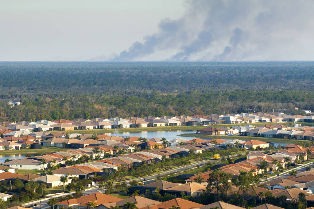 Suburban neighborhood in Florida suffering from bad air quality polluted with prescribed forest fire smoke